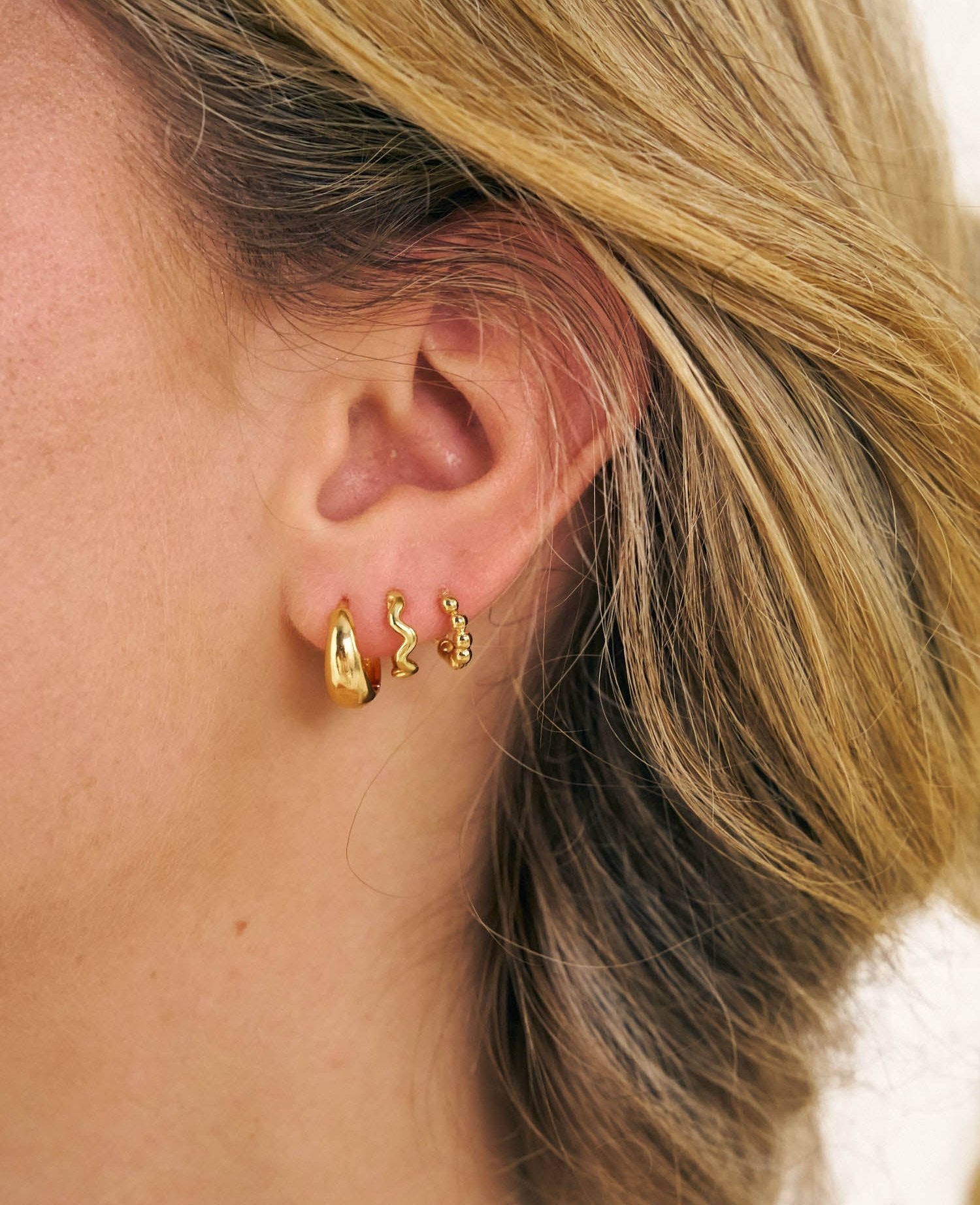 Grip Huggies in an it girl earring stack 