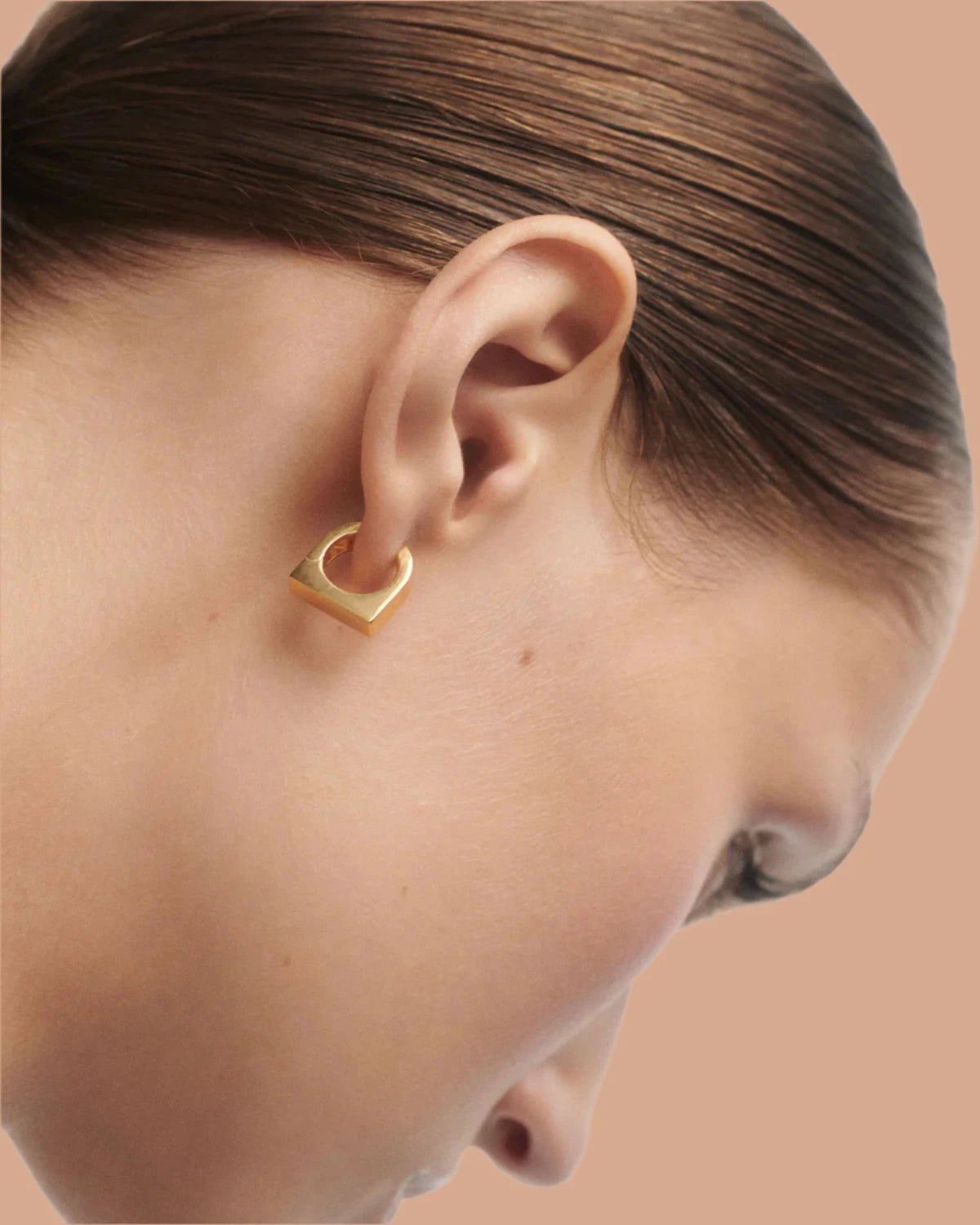 Close up of new classic Maribo gold hoops on models ear