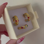 Video of Bixby packaging with multicoloured gemstone ring and earrings in gold
