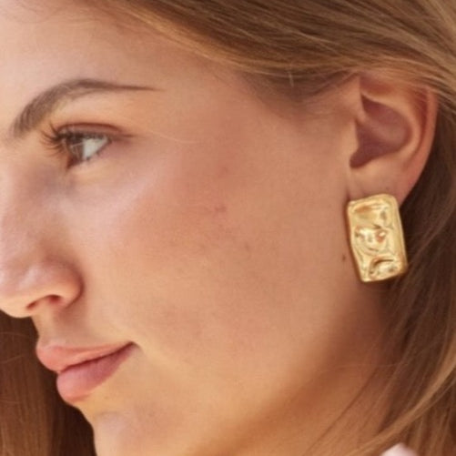 Model wearing gold Bixby earrings 